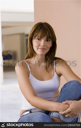 Portrait of young woman on chair