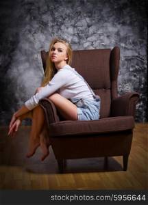 Portrait of young woman on chair