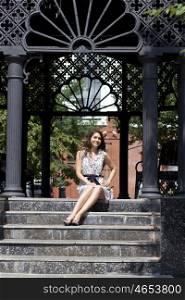 Portrait of young woman on stone steps