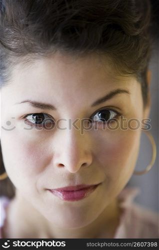 Portrait of young woman raising one eyebrow