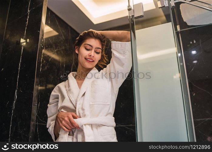 Portrait of young woman relaxed and wrapped in towels after taking a shower at the spa. Spa and lifestyle concept.