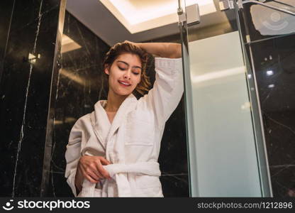 Portrait of young woman relaxed and wrapped in towels after taking a shower at the spa. Spa and lifestyle concept.