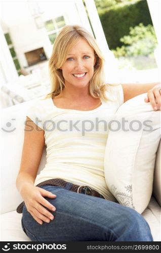 Portrait Of Young Woman Relaxing On Sofa