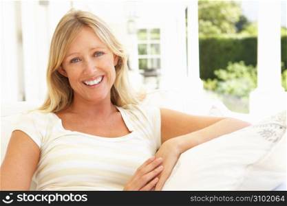 Portrait Of Young Woman Relaxing On Sofa