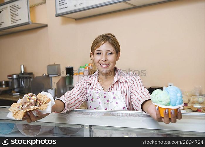 Portrait of young woman serving ice creams