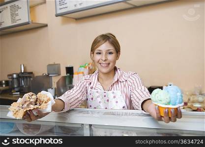 Portrait of young woman serving ice creams