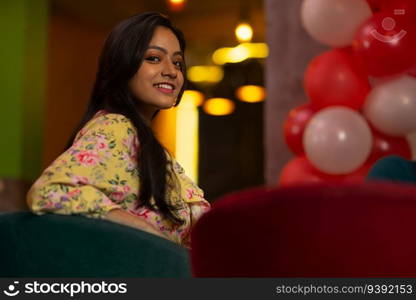 Portrait of young woman sitting at restaurant