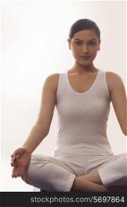 Portrait of young woman sitting in lotus position