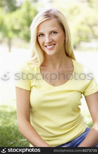 Portrait Of Young Woman Sitting In Park
