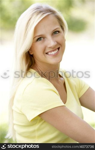Portrait Of Young Woman Sitting In Park