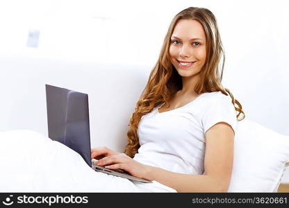 Portrait of young woman sitting with a notebook