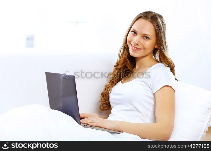 Portrait of young woman sitting with a notebook