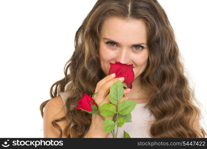 Portrait of young woman smelling red rose