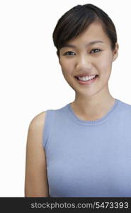 Portrait of young woman smiling against white background