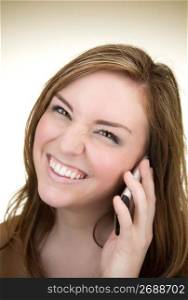 Portrait of young woman smiling and using mobile phone