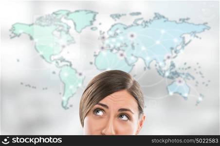 Portrait of young woman standing in front of big world map. Server locations and actual online connections are displayed on virtual map. Hosting provider concept.