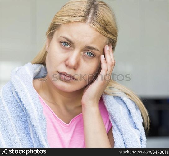 Portrait of young woman suffering from headache