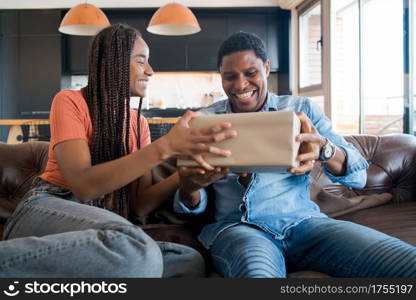 Portrait of young woman surprising her boyfriend with a gift box. Celebration and valentine&rsquo;s day concept.