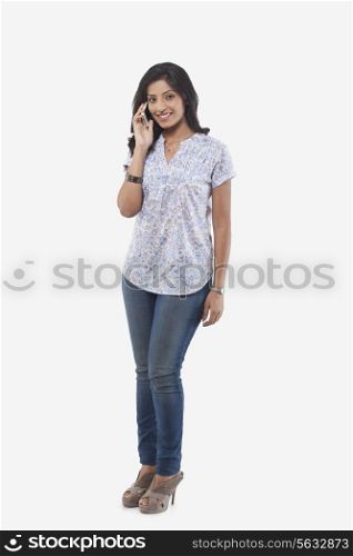 Portrait of young woman talking on mobile phone