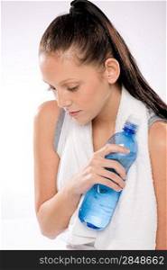 Portrait of young woman thirsty after exercises holding water bottle