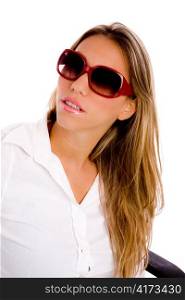 portrait of young woman wearing sunglasses with white background