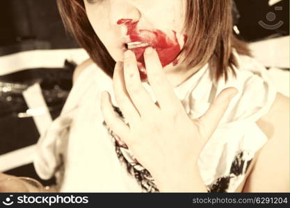 Portrait of young woman with bloodstained face