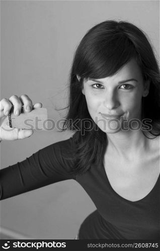 Portrait of young woman with credit card