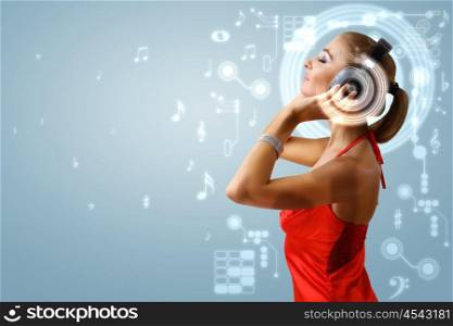 Portrait of young woman with headphones and glittering background