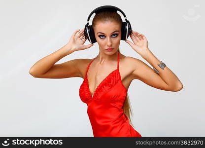 Portrait of young woman with headphones in studio