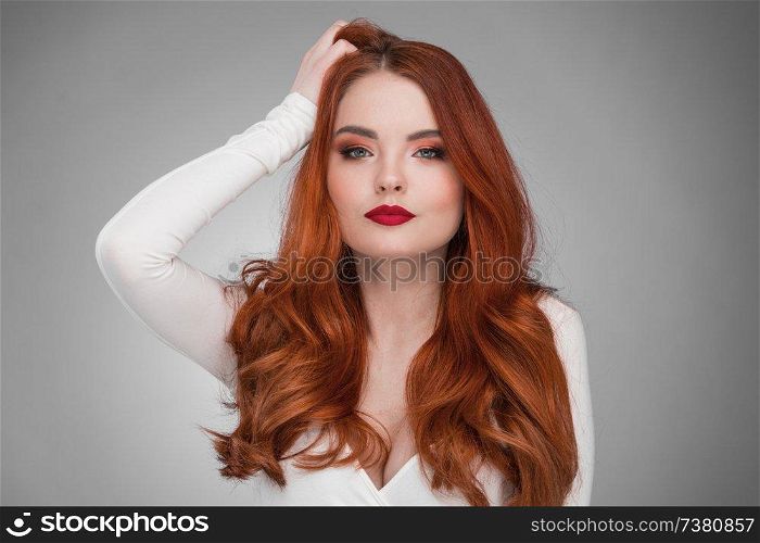 Portrait of young woman with long beautiful ginger hair. Woman with long ginger hair