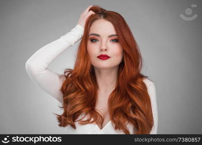 Portrait of young woman with long beautiful ginger hair. Woman with long ginger hair