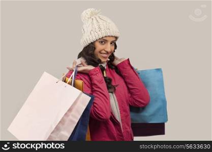 Portrait of young woman with shopping bags