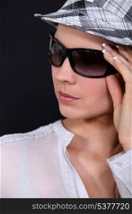 portrait of young woman with sunglasses and cap