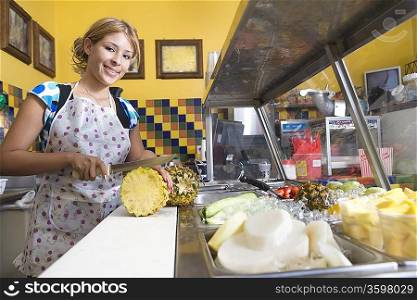 Portrait of young woman working in diner