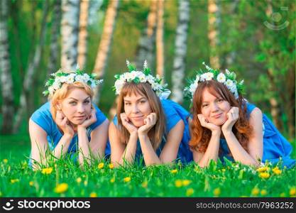 Portrait of young women having a rest on a lawn in park