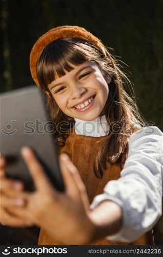 portrait pretty little girl taking selfie