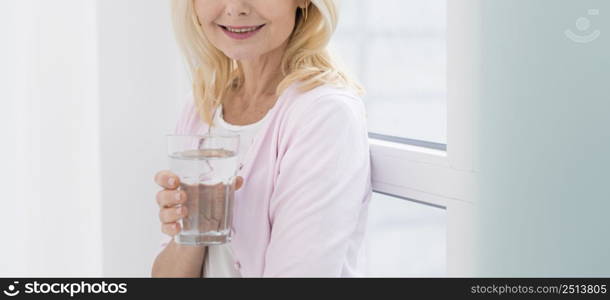 portrait pretty mature woman holding glass water