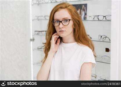 portrait serious attractive woman looking camera optics store