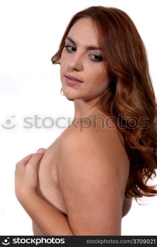 Portrait shot of a beautiful nude redhead woman.