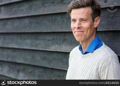 Portrait shot of an attractive, handsome, successful and happy middle aged man male outside wearing a sweater