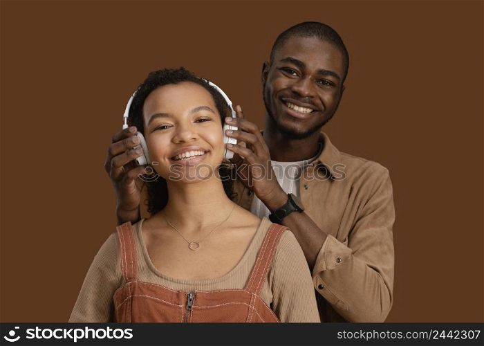 portrait smiley couple with headphones
