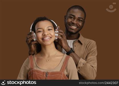 portrait smiley couple with headphones