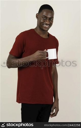 portrait smiley man t shirt holding mug