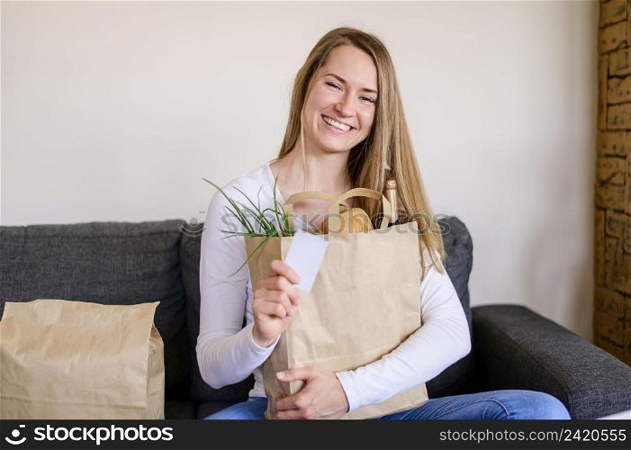 portrait smiley woman holding groceries bag