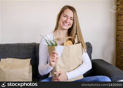 portrait smiley woman holding groceries bag