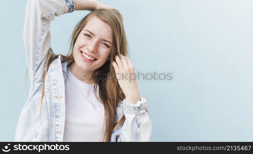 portrait smiling attractive woman blue wall