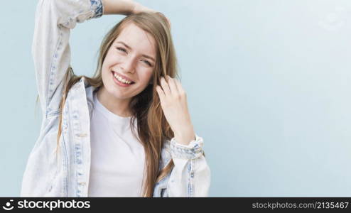 portrait smiling attractive woman blue wall