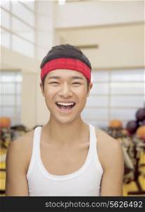 Portrait smiling young man at the gym