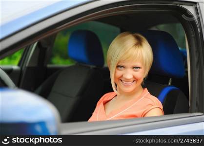 portrait smiling young woman in the car
