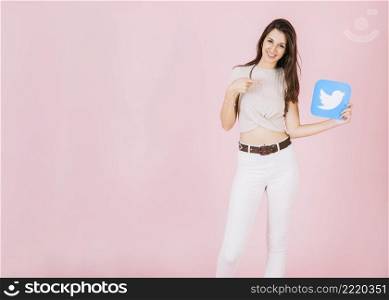 portrait smiling young woman pointing twitter icon